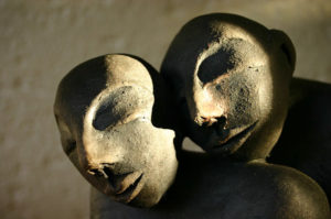 Heads of man and women in stone sculpture representing evolutionary time
