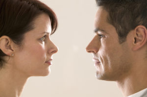 Faces of man and woman, inches apart, with direct face-to-face eye contact
